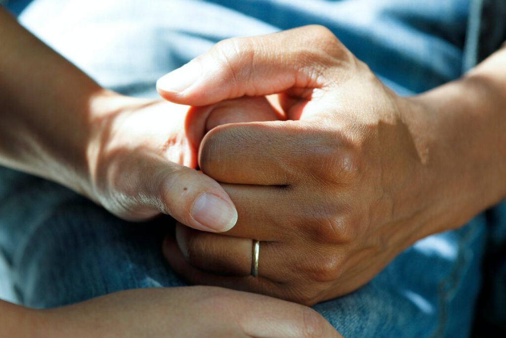 Photograph of a carer holding a hand to show an aspect of home care in the Colne Valley Huddersfield Kirklees